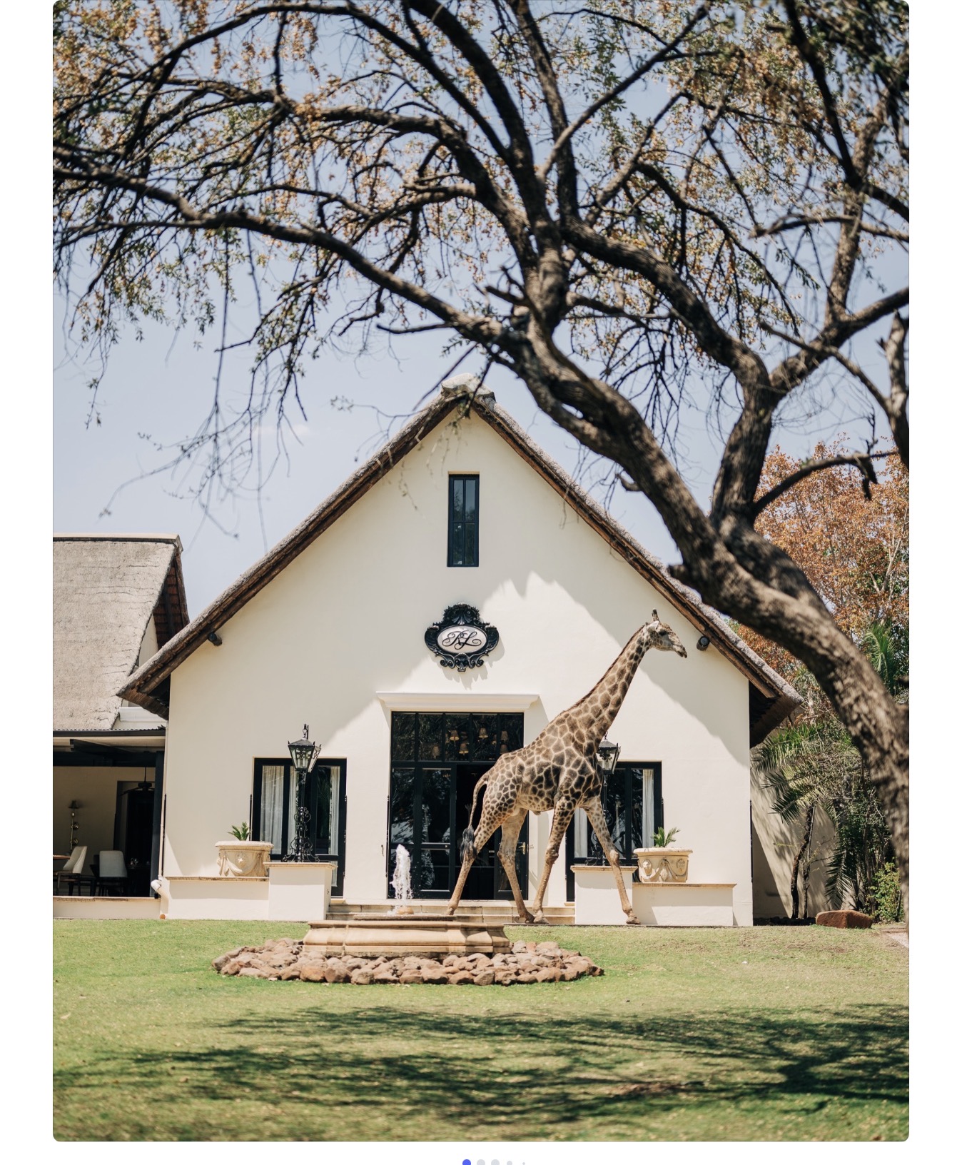 The Royal Livingstone Hotel with a giraffe on the manicured lawns, Zambia